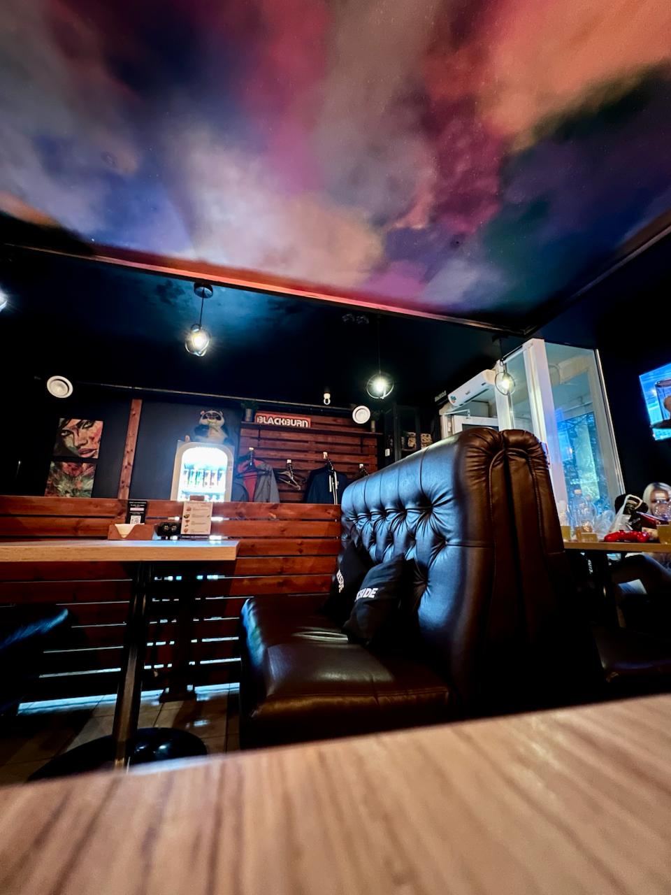 Lounge hall under a dark galaxy ceiling