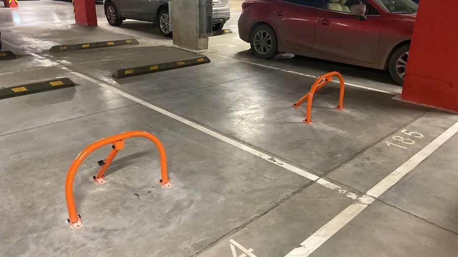 Two fold-down parking barriers in an underground car park