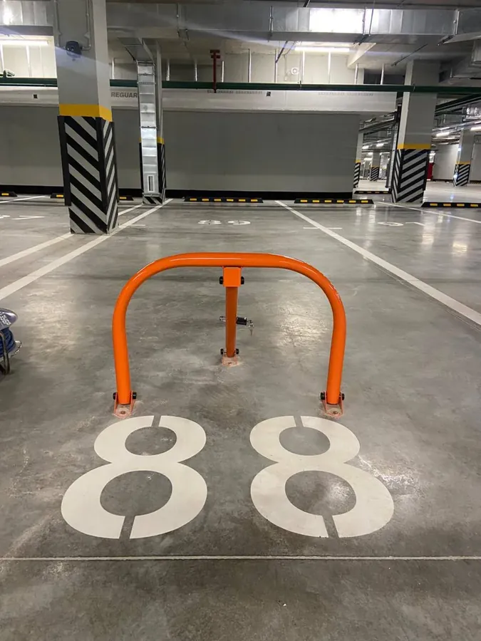 Fold-down barrier in a covered car park