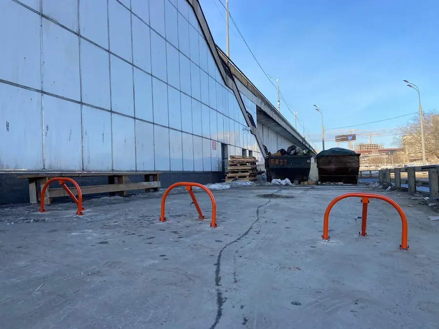 Three fold-down barriers by a warehouse wall