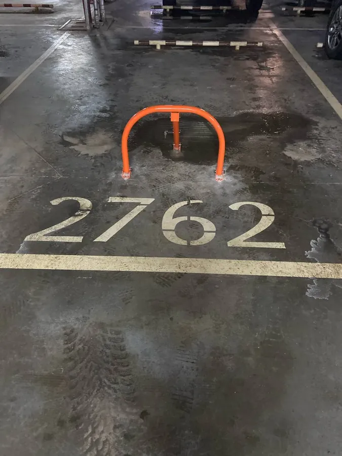 Fold-down barrier on a numbered bay